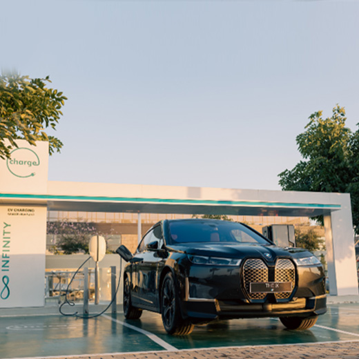 BMW i5 eDrive40 G60 at charging station in front of a lake